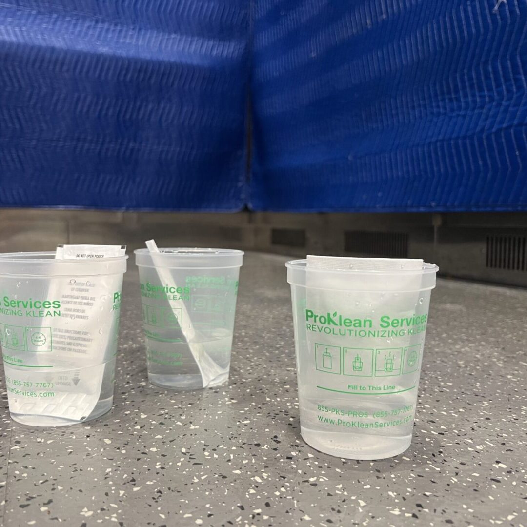 Three plastic cups on the floor of a subway station.