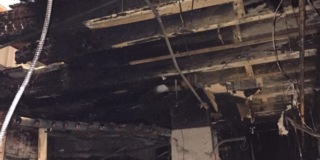 The damaged ceiling of a building that has been affected by fire may require odor control.