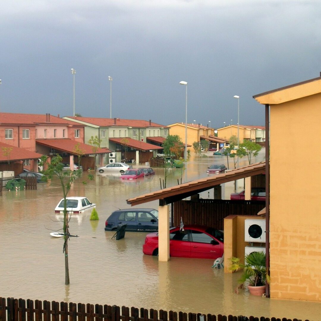 A car parked in a flooded street.